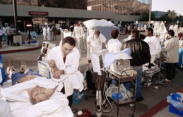 Triage workers attending to patients outside a hospital