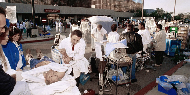 Triage workers attending to patients outside a hospital